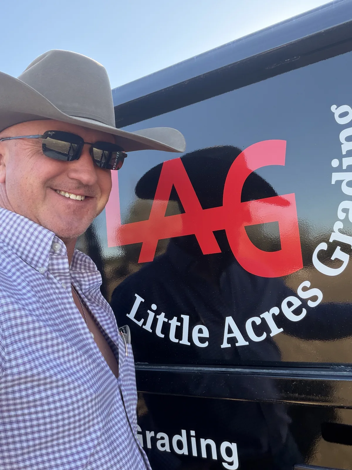 Rodney Little, owner of Little Acres Grading, beside the company truck