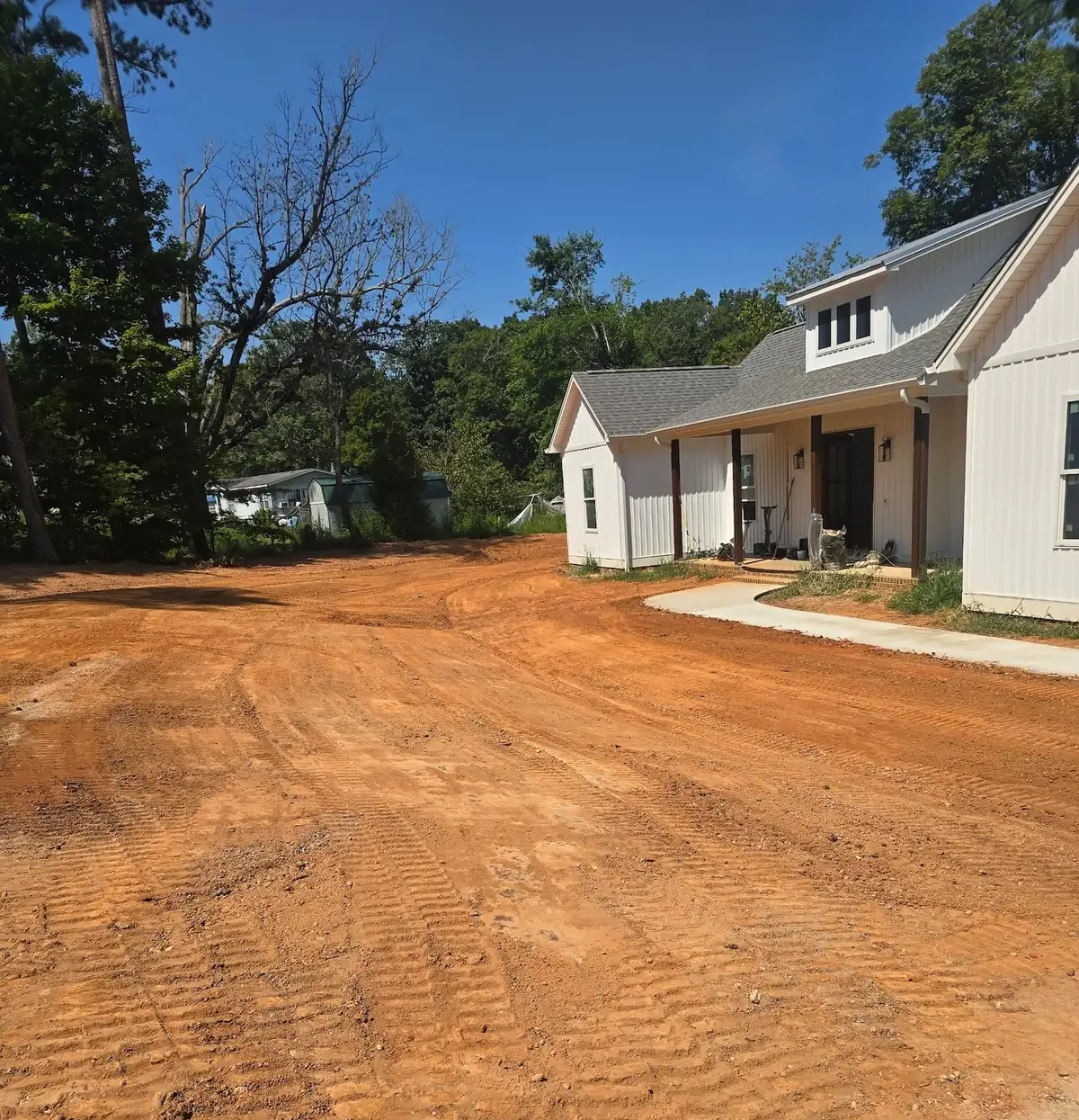 A yard cut and shaped to grade around a newly built farmhouse — Little Acres Grading