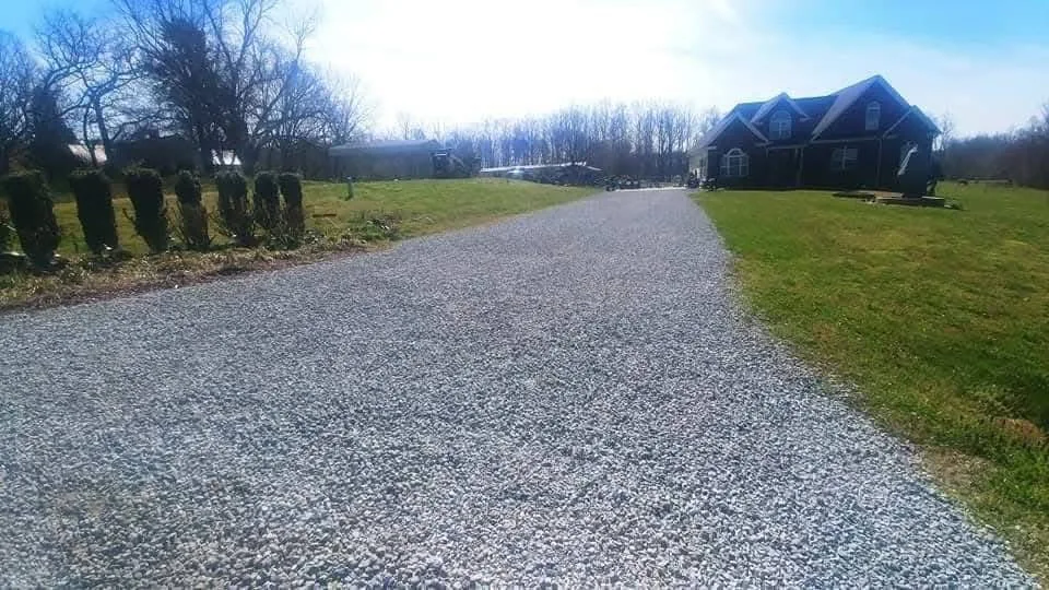 A long straight gravel drive graded and crowned to shed water — Little Acres Grading