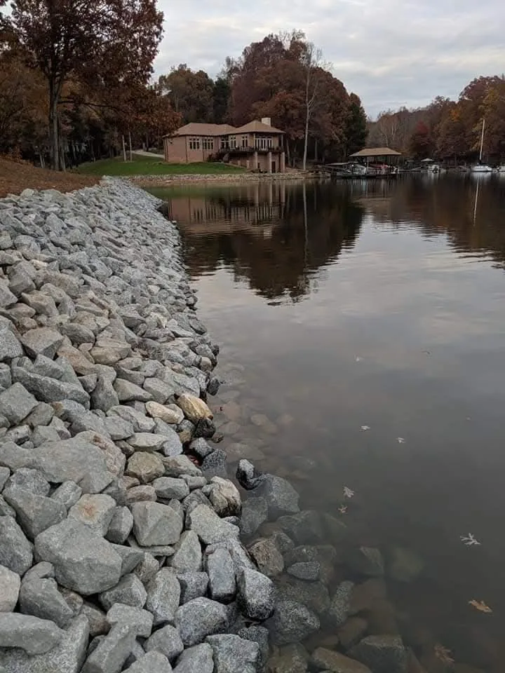 Rip-rap set along a lake shoreline to stop bank erosion — Little Acres Grading
