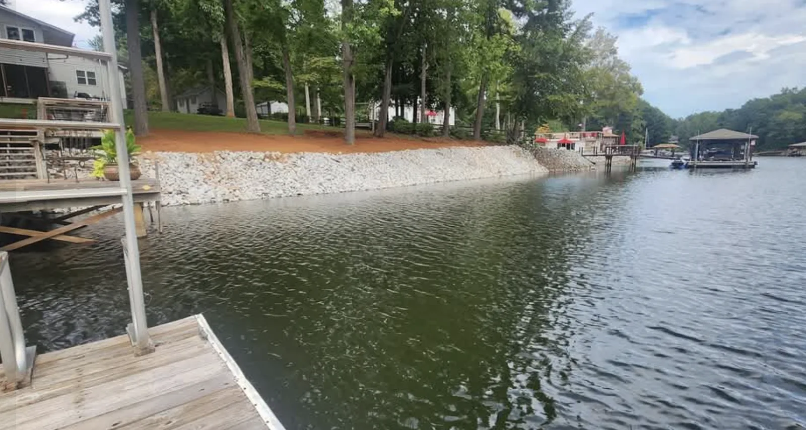 A long run of rip-rap armouring a lake shoreline — Little Acres Grading